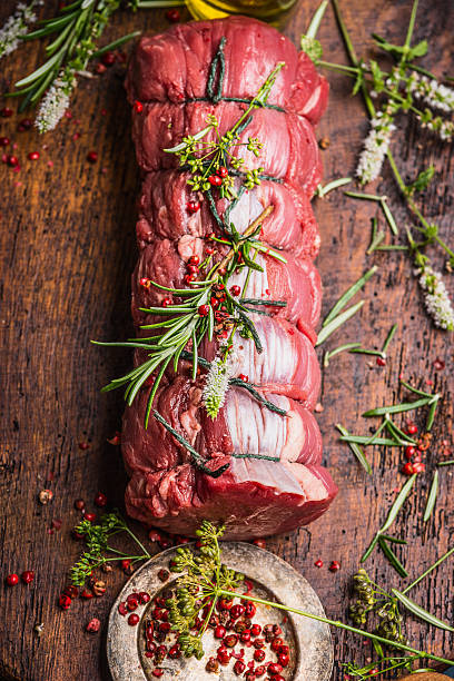 Raw roast beef  with herbs and spices, close up stock photo