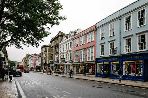 Oxford, United Kingdom - August 12, 2015: High Street in Oxford a rainy day.  This street is the center of the city and is well known for Major buildings and commerce. The city is known as the home of the University of Oxford.