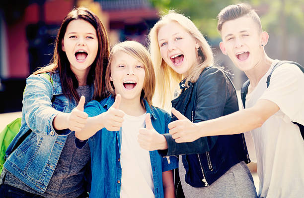 istock Girls and boys posing with thumbs up 596789320