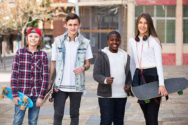 istock Four teens with skateboards outdoors 596789486