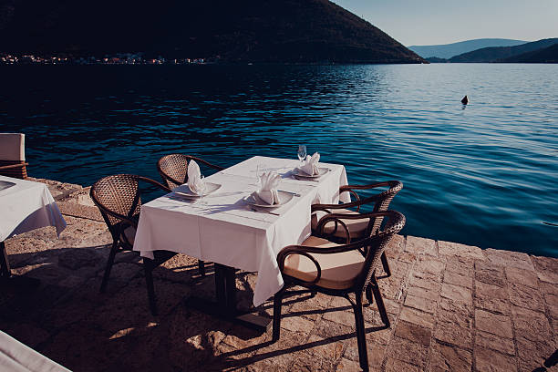 istock Served scenic cafe table near the sea 596789904