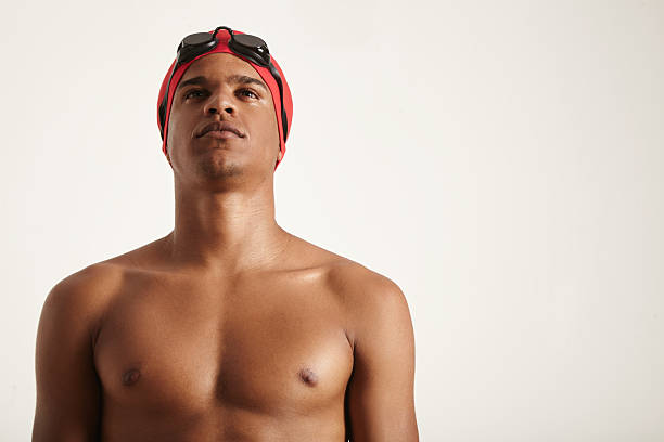 istock Young African American swimmer in red cap and black goggles 596791332