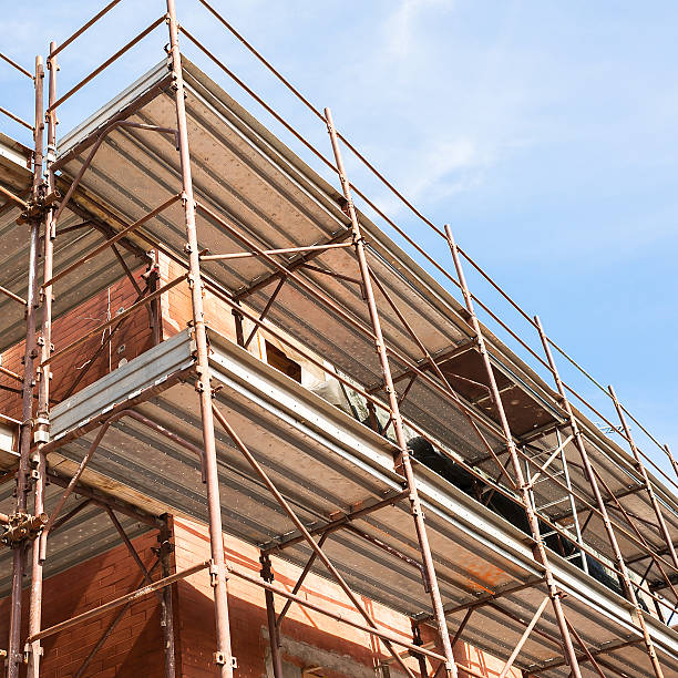 istock House for renovation with the scaffolding for bricklayers 596792768