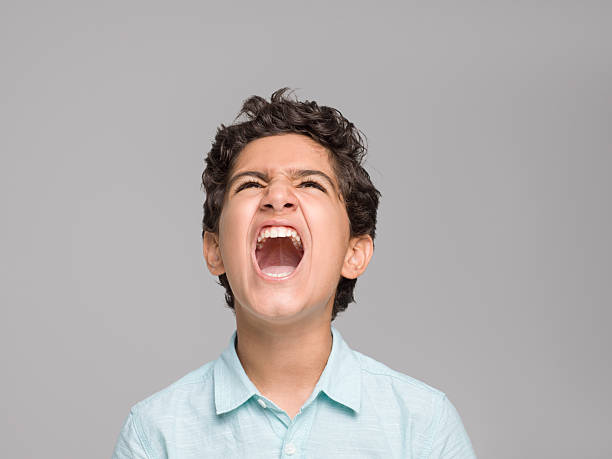 istock Portrait of screaming young boy 596794652