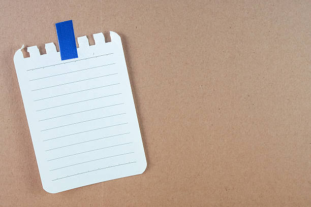 istock abstract of note paper with blue tape on board 596795452