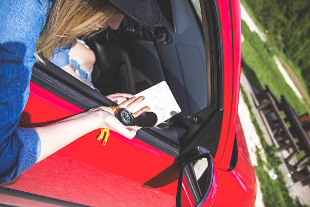istock woman using a compass for travelers 596796192