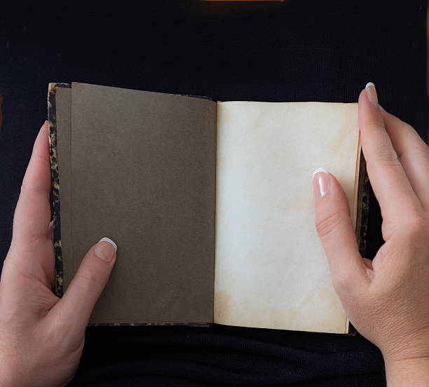 istock Personal perspective woman starting to read an old book 596796284