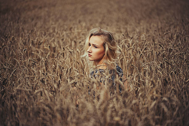 istock young beautiful girl in autumn field 596796964