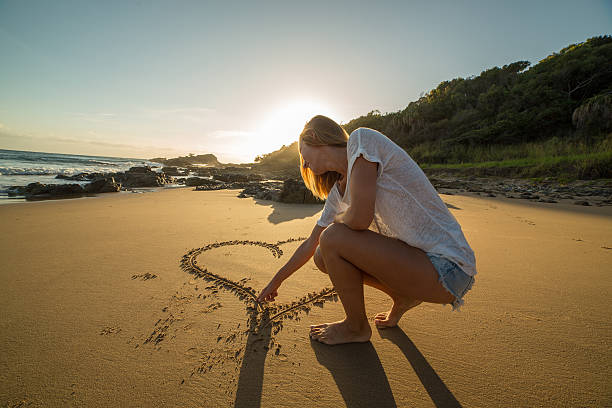 istock Young woman loving beach at sunrise 596798188