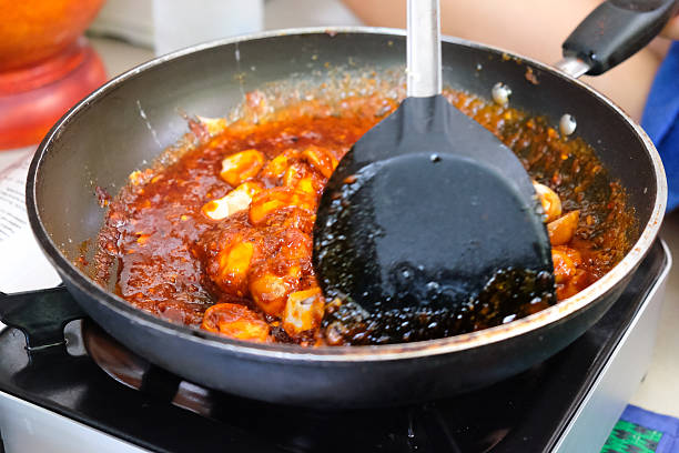 istock Chef cooking Thai style food with mushroom 596798326
