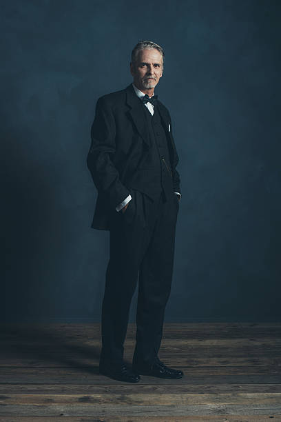 istock Confident middle aged retro 1920s businessman in black suit. 596798488
