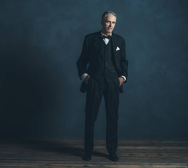 istock Confident middle aged retro 1920s businessman in black suit. 596798518