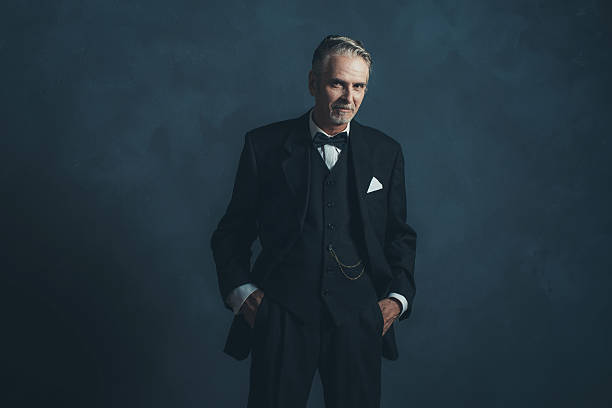 istock Confident middle aged retro 1920s businessman in black suit. 596798592
