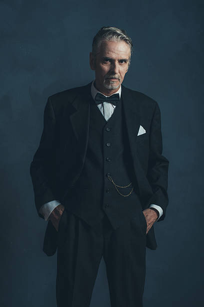 istock Confident middle aged retro 1920s businessman in black suit. 596798620