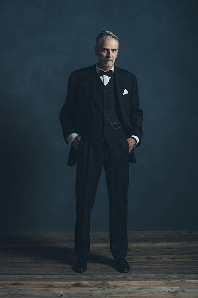 istock Confident middle aged retro 1920s businessman in black suit. 596798642
