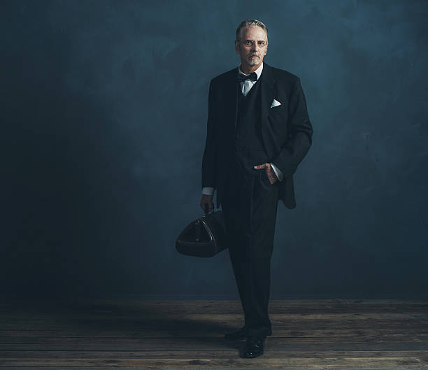 istock Retro 1920s doctor in black suit with bow tie. 596798870