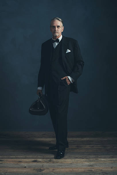 istock Retro 1920s doctor in black suit with bow tie. 596798904