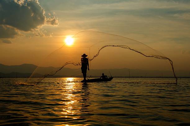 istock Fisherman , Silhouette fisherman. 596800086
