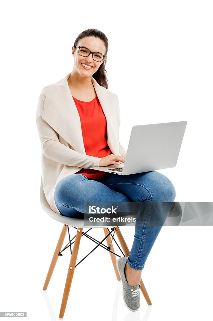 Working with a laptop Beautiful and happy woman working with a laptop, isolated over white background Women Stock Photo