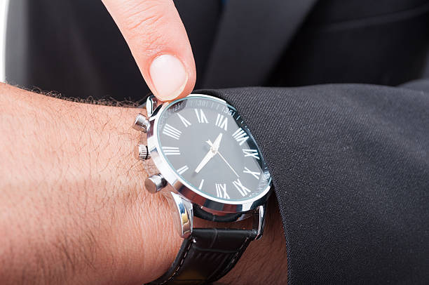 istock Male manager pointing watch in closeup 596801028
