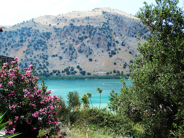istock sunbeds near mountain lake Greece 596801440