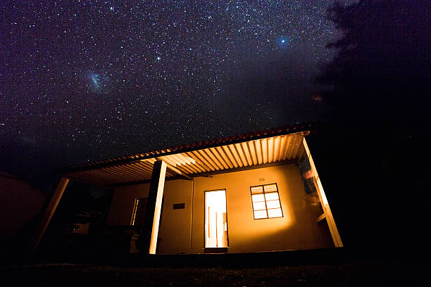istock Stars shine brightly above small isolated cabin retreat 596802000