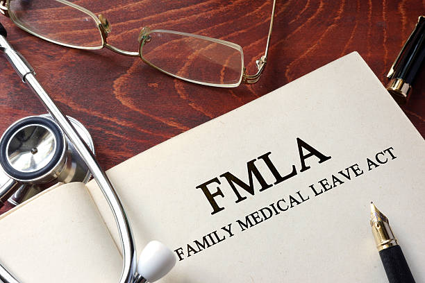 istock Page with FMLA family medical leave act on a table. 596803508
