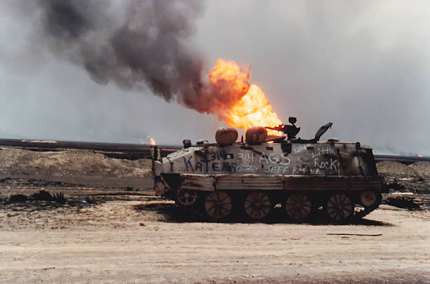 Tank and oil well fire, Kuwait, Persian Gulf War stock photo
