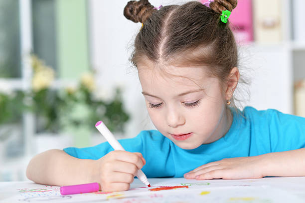 istock Little girl drawing at  class 596804400