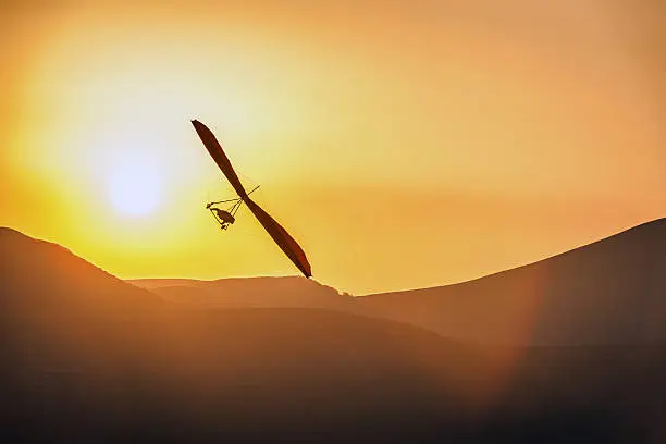 An ultralight plane against sunset sky ,hang Glider Pilot Launching ,Apennines,Italy,Nikon D3x