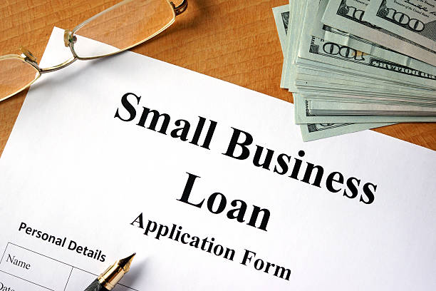 istock Small business loan form on a wooden table. 596805584