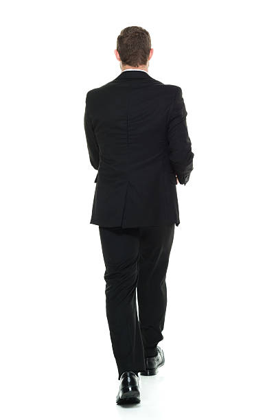 istock Rear view of businessman walking 596808044