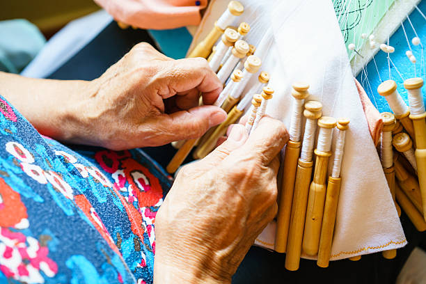istock Close-up of woman weaving using bobbins 596812262