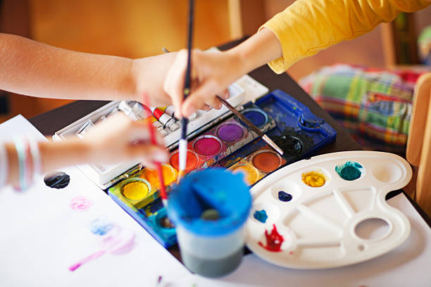 In art class Close up image on children using different colours in art class, shallow depth of field pastel crayon photos stock pictures, royalty-free photos & images