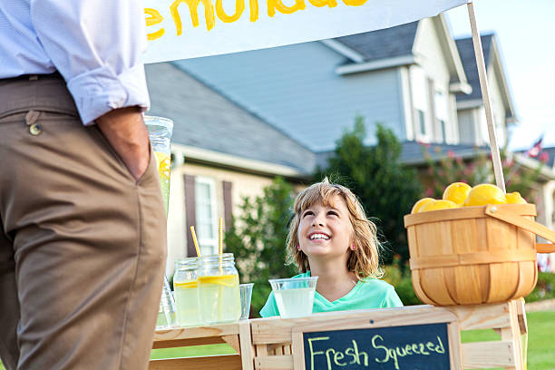istock Little sells lemonade to a customer 596814126