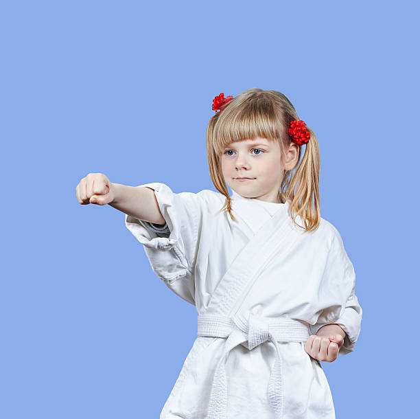 istock On a blue background sportswoman beats punch arm 596814320