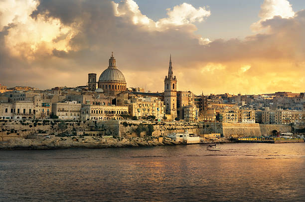 Valletta skyline waterfront at sunset. Malta Panoramic view of Valletta at sunset with Carmelite Church dome and St. Pauls Anglican Cathedral. Malta valletta photos stock pictures, royalty-free photos & images