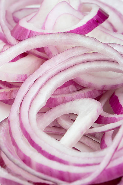 istock slices of red onion isolated on white 596817116