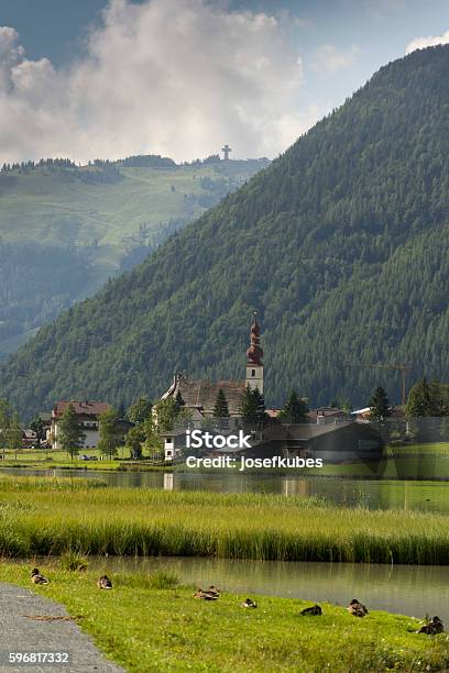 Sankt Ulrich Am Pillersee With Jakobskreuz On The Buchensteinwand Summit Stock Photo - Download Image Now