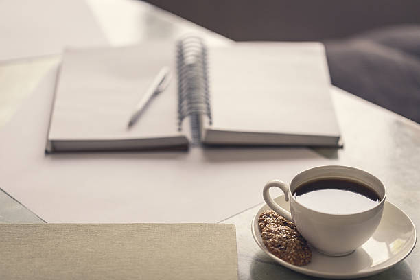 istock Blank notebook, pen and cup of coffee on office desk. 597210632
