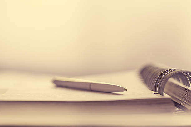 istock Notebook with pen on vintage office desk. 597211010