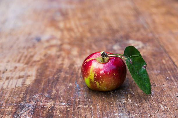 istock Red ripe apples at dark wooden table. 597213530