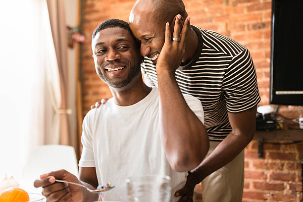 homosexual couple doing breakfast on the kitchen togetherness homosexual couple doing breakfast on the kitchen togetherness homosexual couple stock pictures, royalty-free photos & images