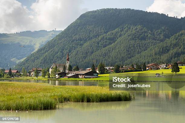 Sankt Ulrich Am Pillersee With Jakobskreuz On The Buchensteinwand Summit Stock Photo - Download Image Now