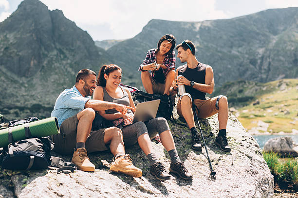 istock Friends browsing the net in the mountain 597224502