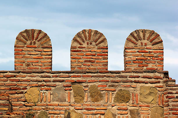 istock Old brick stone fortress wall with battlements 597227188