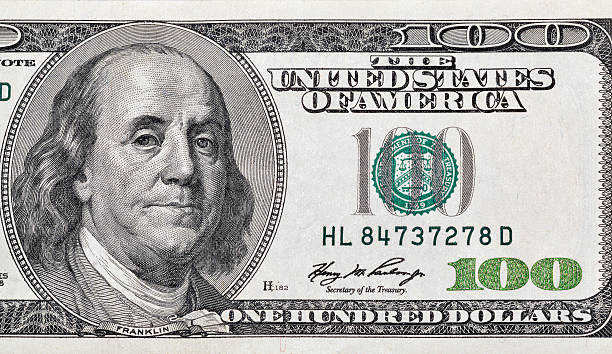 istock One hundred dollar bill fragment closeup 597227370