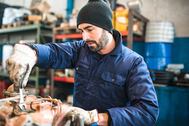 istock mechanic working in a workshop on a truck engine 597228616