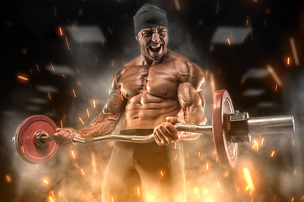 Big angry athlete trains in the gym
