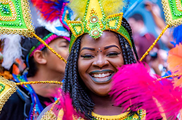Street dancer is having fun at London’s Notting Hill Carnival London, UK - August 29, 2016: Notting Hill Carnival is the largest street party in Europe and takes place at the Royal Borough of Kensington and Chelsea each August over the two days of bank holiday notting hill stock pictures, royalty-free photos & images